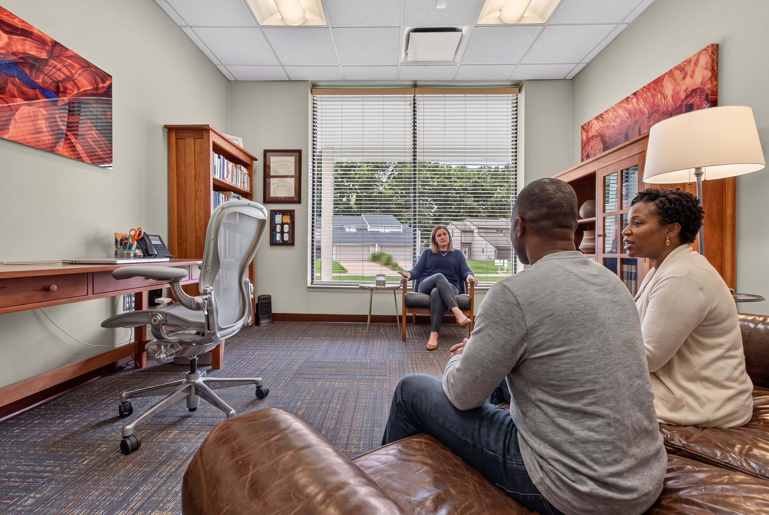 A couple in session with their counselor at Genesis